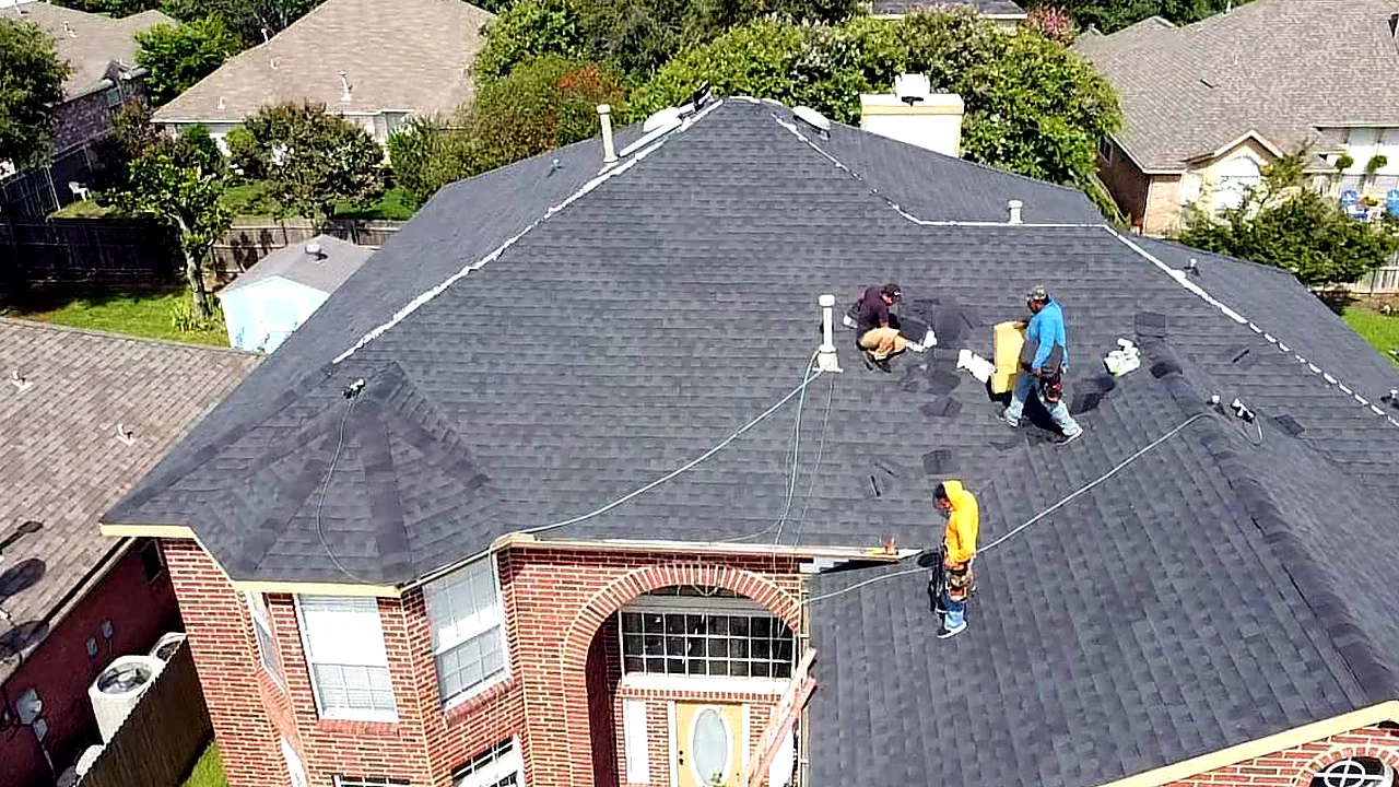 850 Roofing crew installing shingles on a brick home